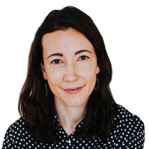 Anna Koob, a woman with long, dark hair, smiles at the camera.