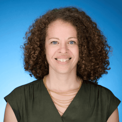 Headshot of Rachel M. Kimber, Managing Director at Full Circle Impact Solutions, in a dark green top.