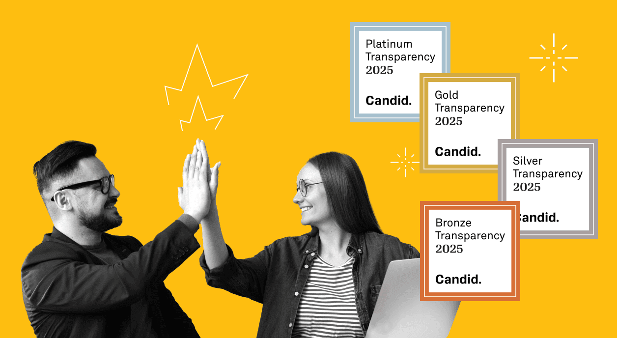 Two colleagues high-fiving after earning a 2025 Candid Seal of Transparency.