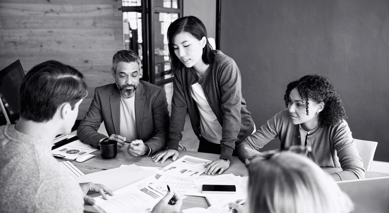 A woman reviews different funding opportunities with her team.