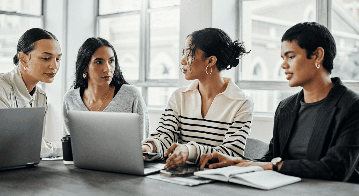 A team of diverse women dealing with nonprofit burnout.