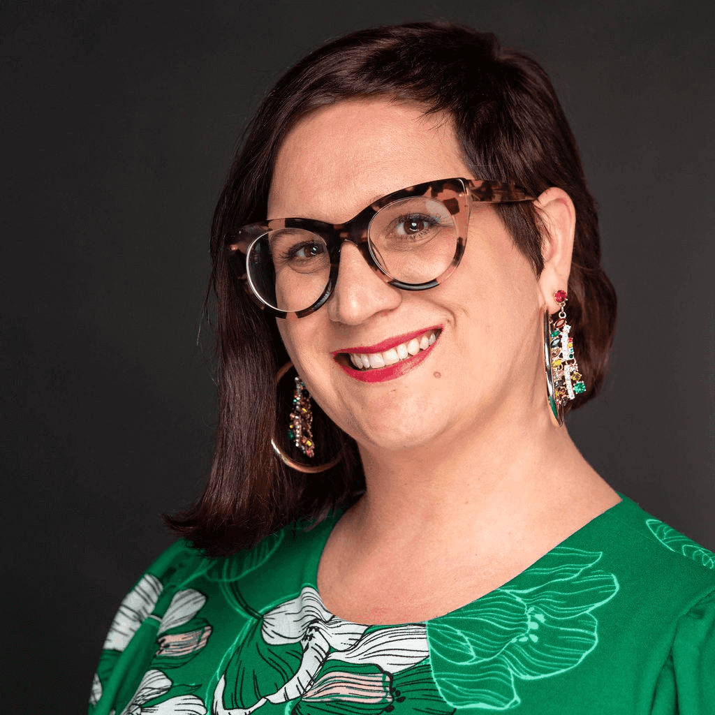 Headshot of Amanda Cole, executive director of Plexus LGBT & Chamber of Commerce, in a green top.
