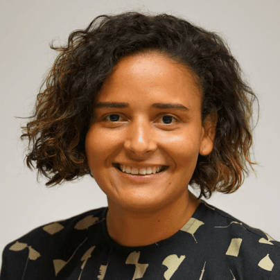 Headshot of April Bethea, Director of External Affairs, Funders for LGBTQ Issues, in a black and beige patterned top.