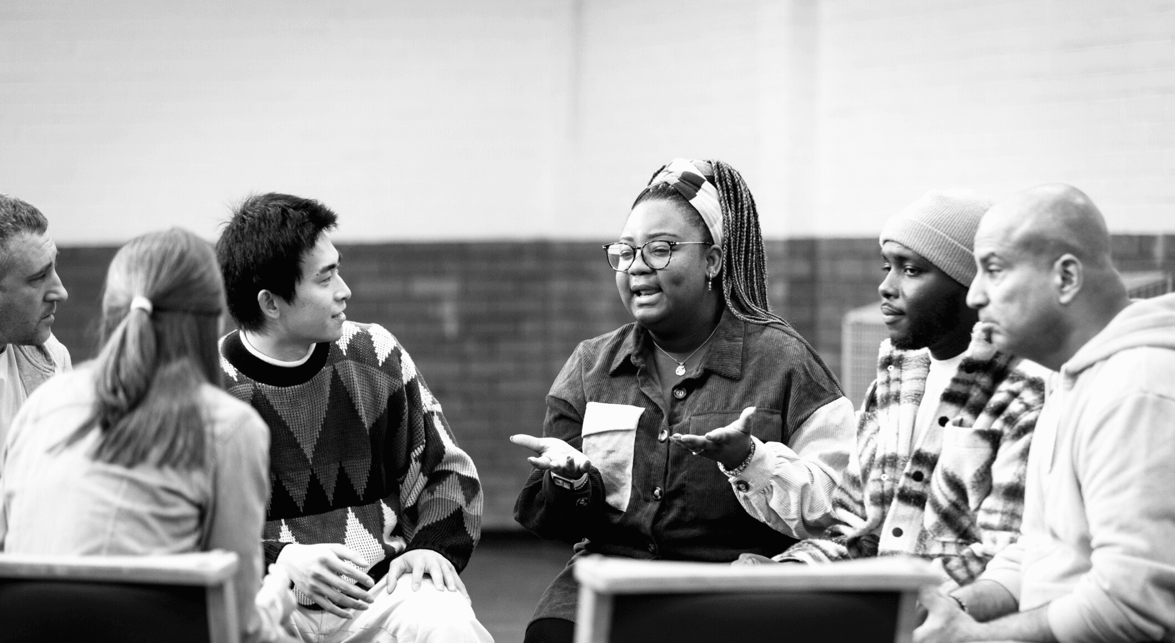 A group of diverse individuals having a discussion.
