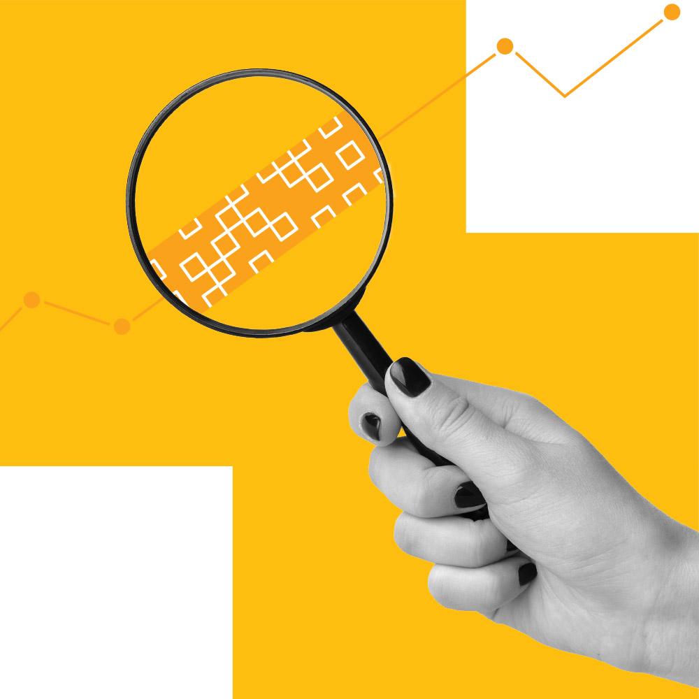 Someone looking at a piece of data through a microscope.