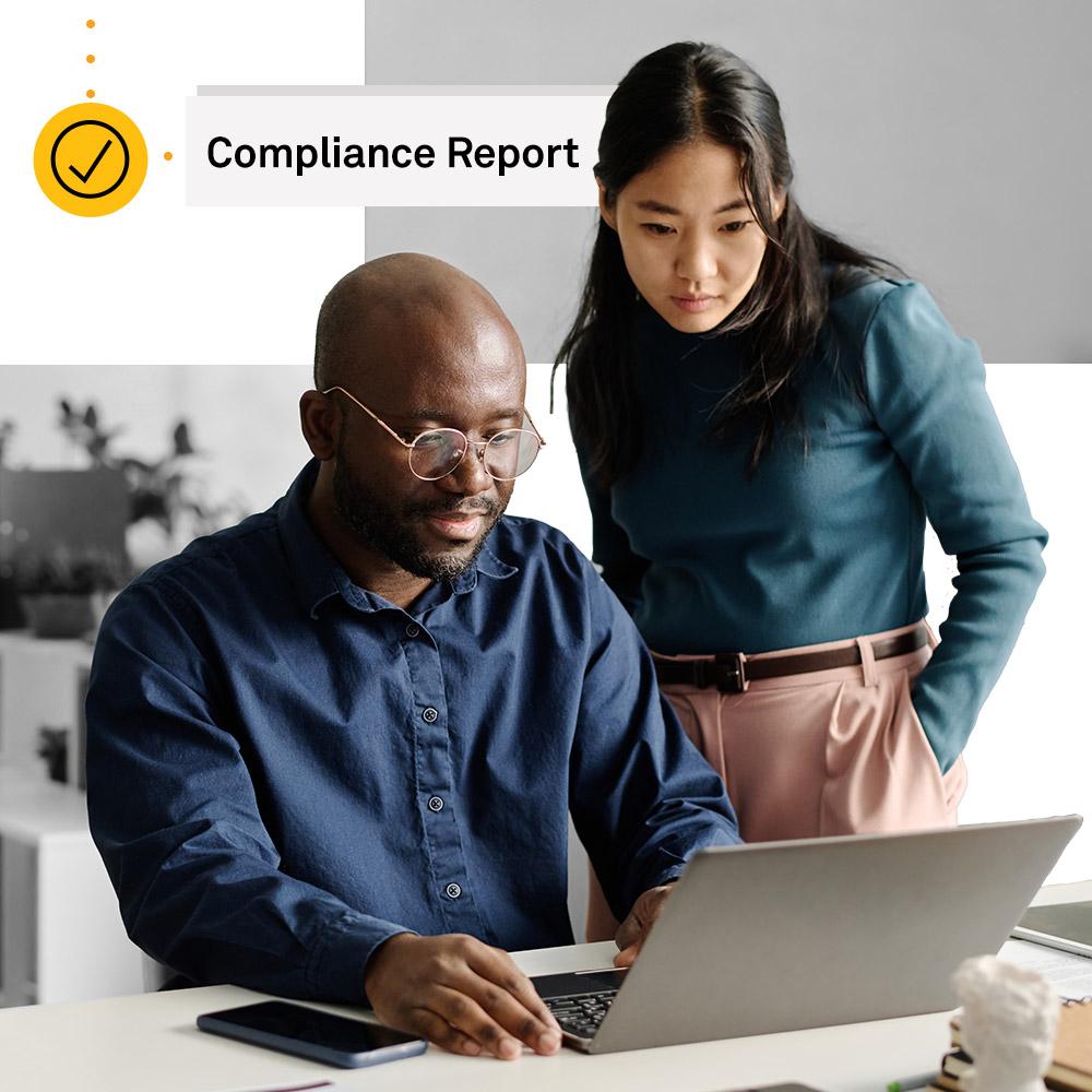 Two colleagues looking at a compliance report to verify nonprofits.