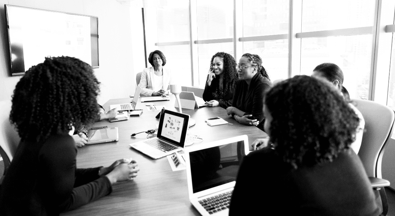 Woman work together to learn more about technology.