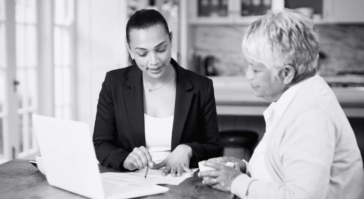 A lawyer works with a woman to understand her options for legal aid.
