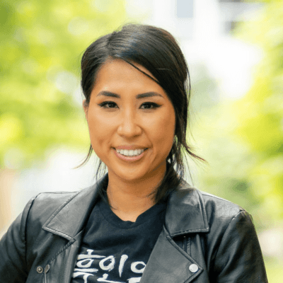 Headshot of Esther Saehyun Lee, founder and principal of Elevate Philanthropy Consulting, in a black T-shirt and jacket.
