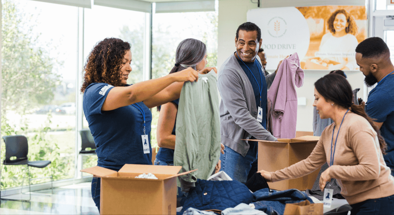 A diverse group of volunteers sorting clothes.