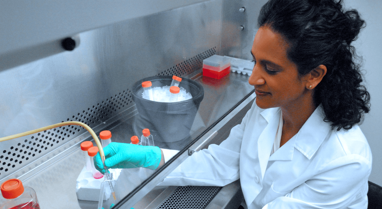 A woman does cancer research in a lab.