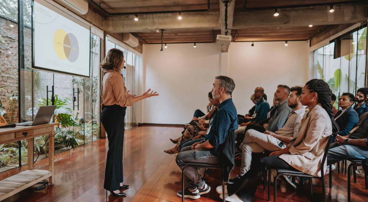 A nonprofit CEO speaking in front of staff.