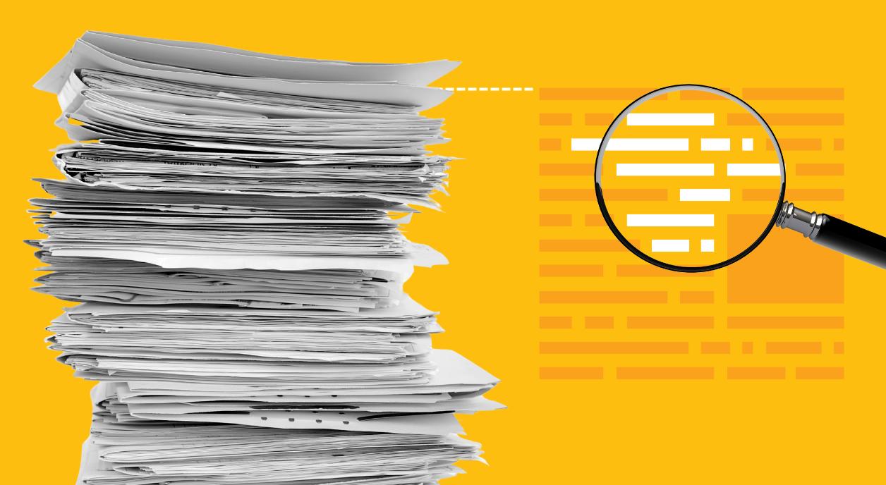 A stack of research papers being magnified.